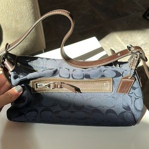 Navy blue Coach small bag. Can fit wallet, phone, makeup, and keys!